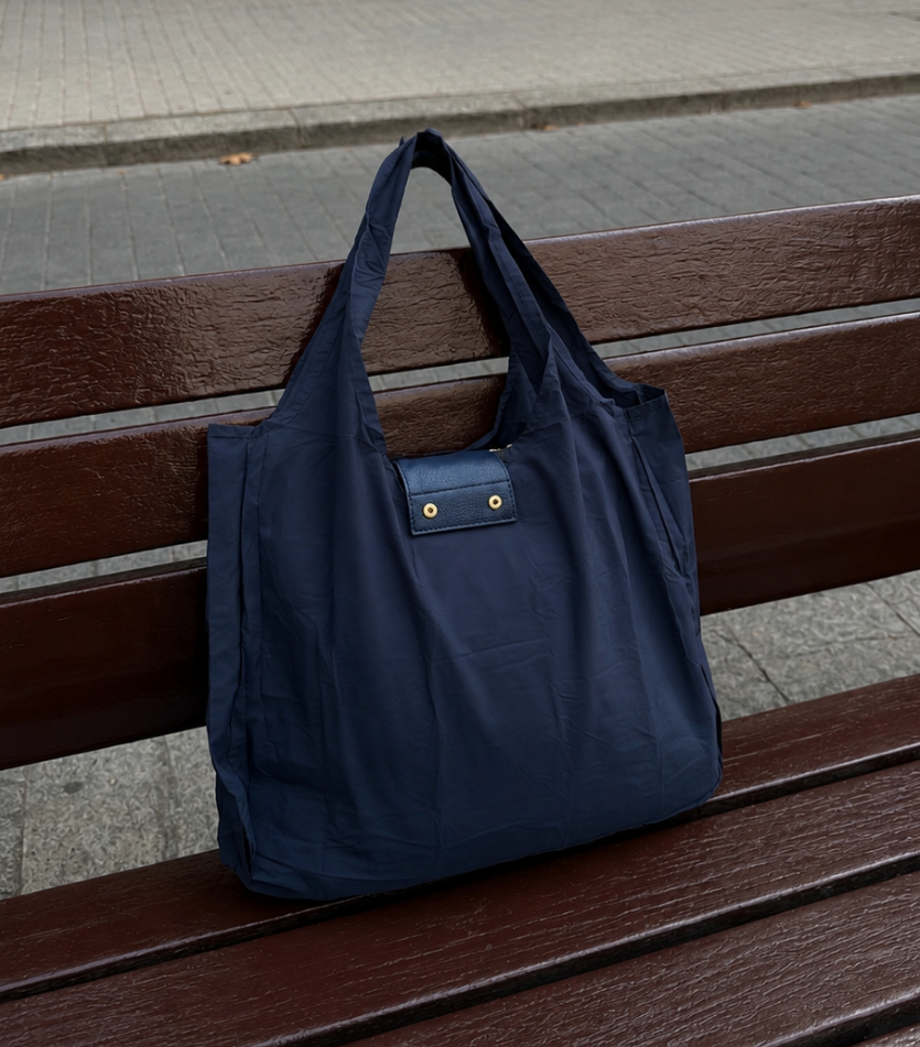 Navy foldable tote on a bench