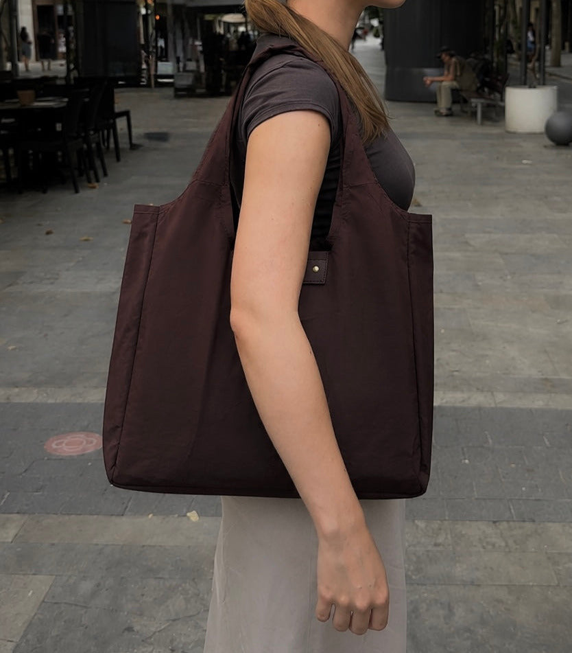 Brown foldable tote worn over the shoulder