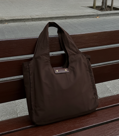 Brown foldable tote on a bench