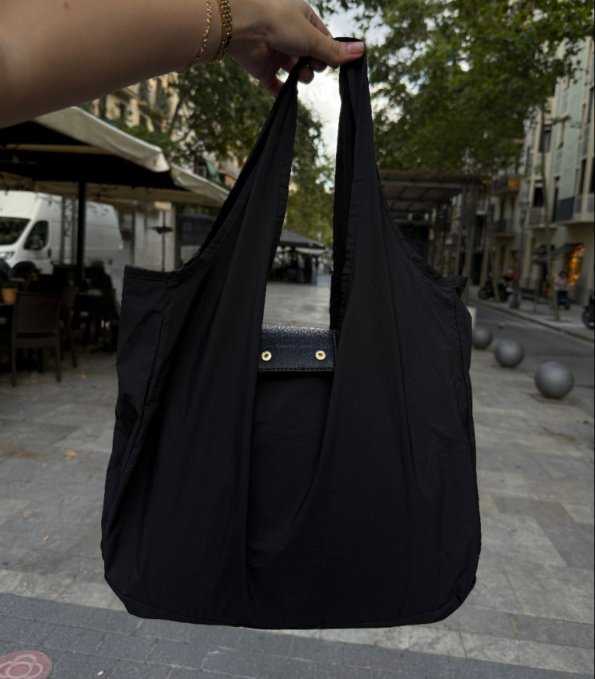 Black foldable tote with snap closure detail