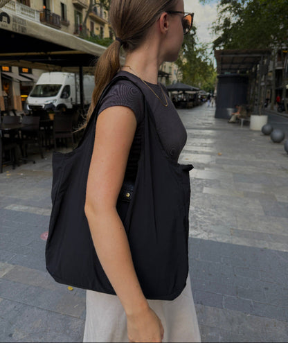 Black reusable tote in everyday use