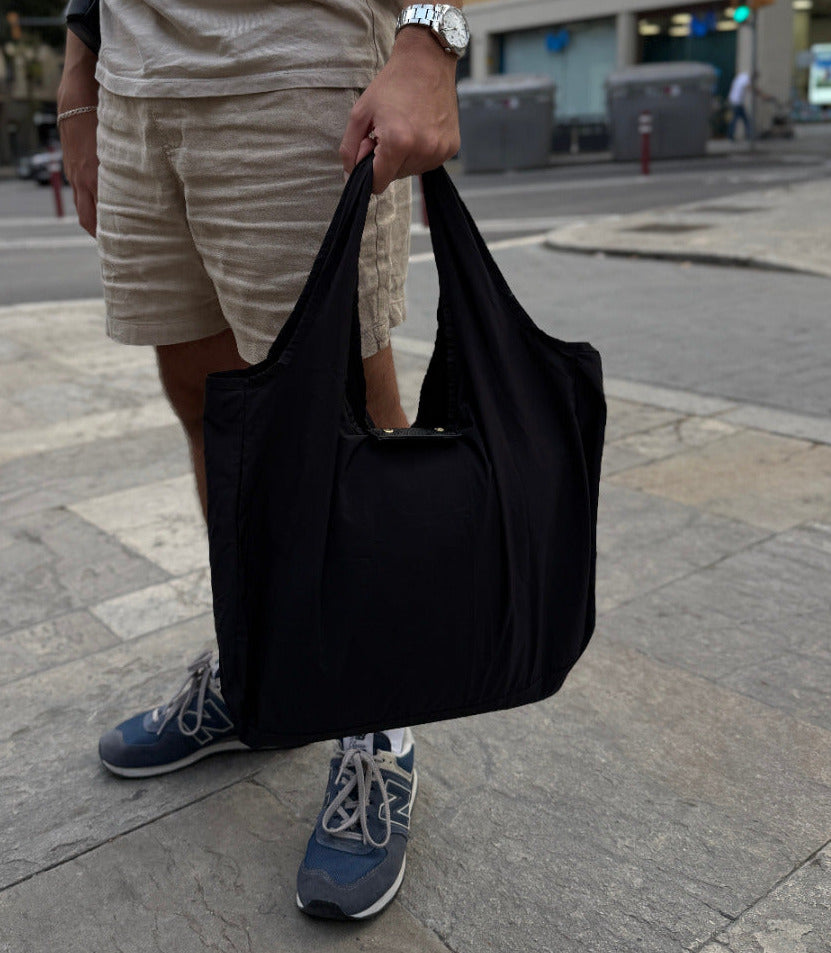 Black lightweight shopping tote carried by hand