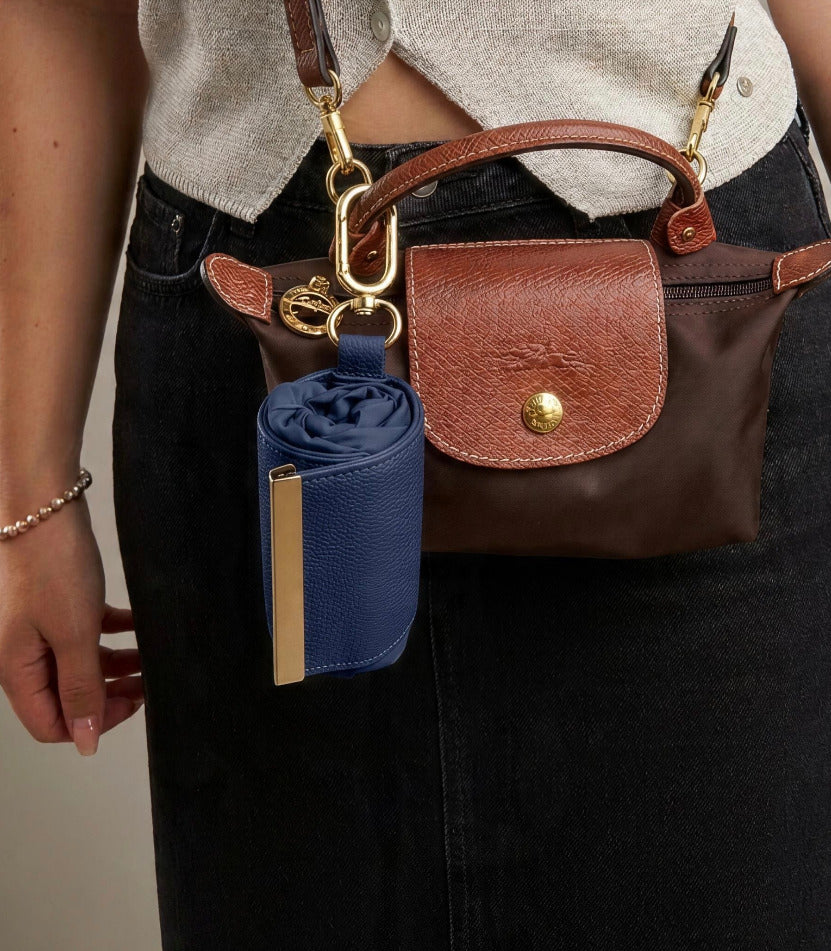 Navy compact pouch clipped to handbag