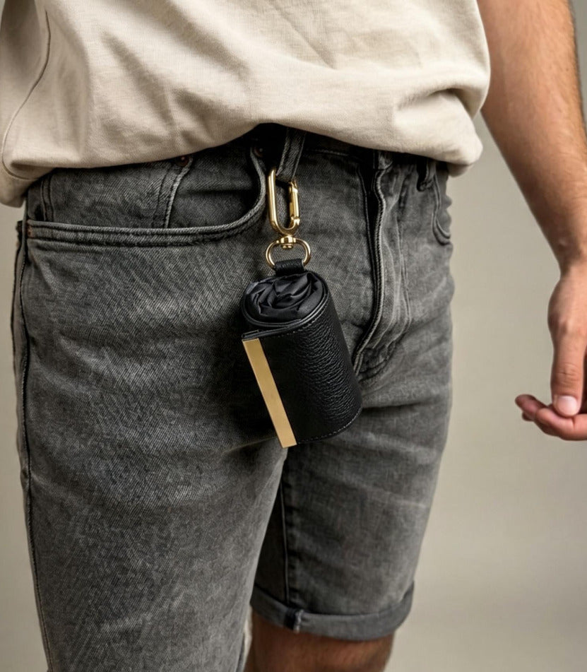 Black compact pouch clipped to belt loop