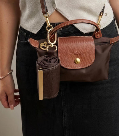 Brown compact pouch clipped to handbag